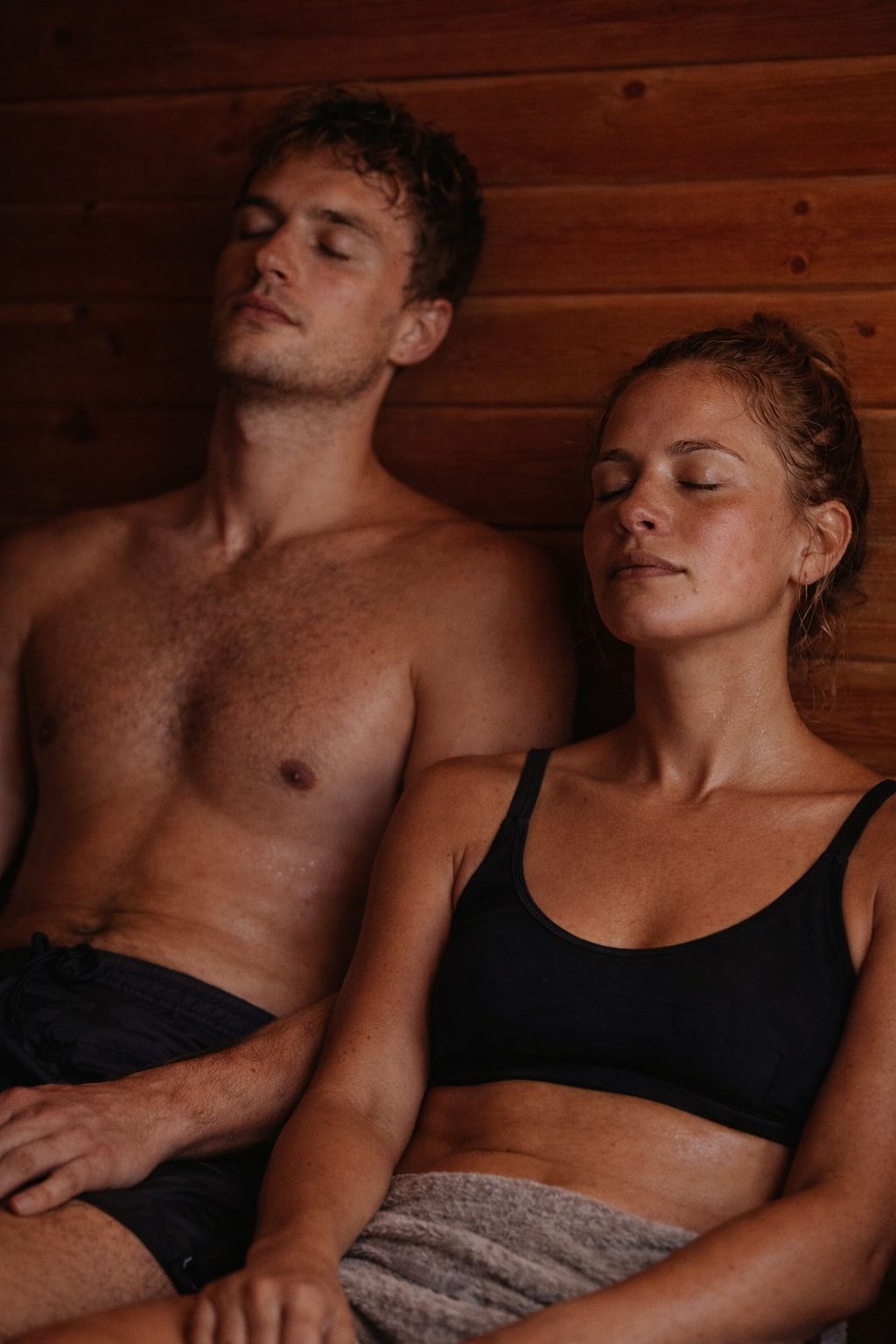 Couple relaxing in the sauna with eyes closed